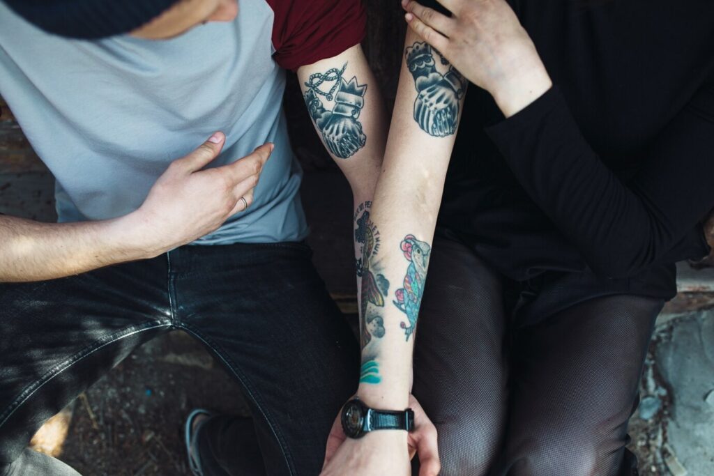 couple looking at their new tattoo
